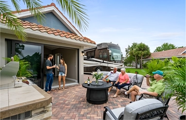 A group of people standing around an outdoor patio.