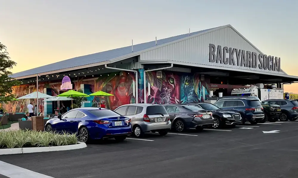 A row of parked cars in front of a building.