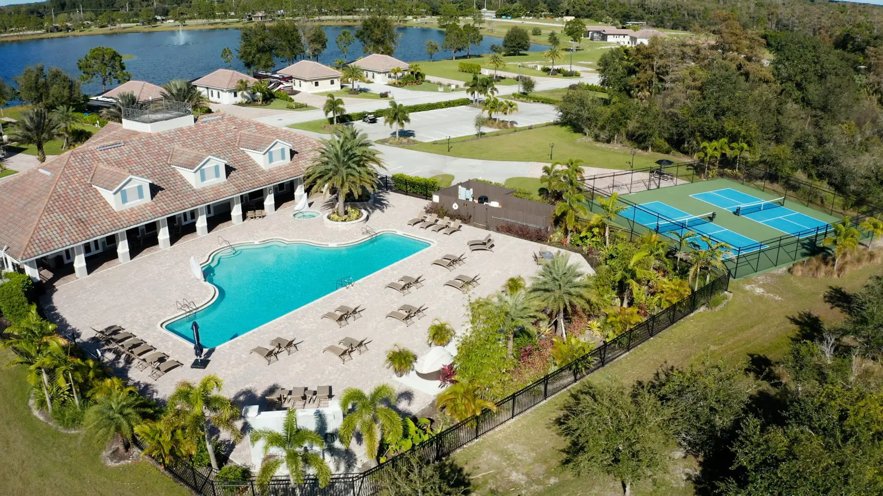 A large pool with many trees and grass