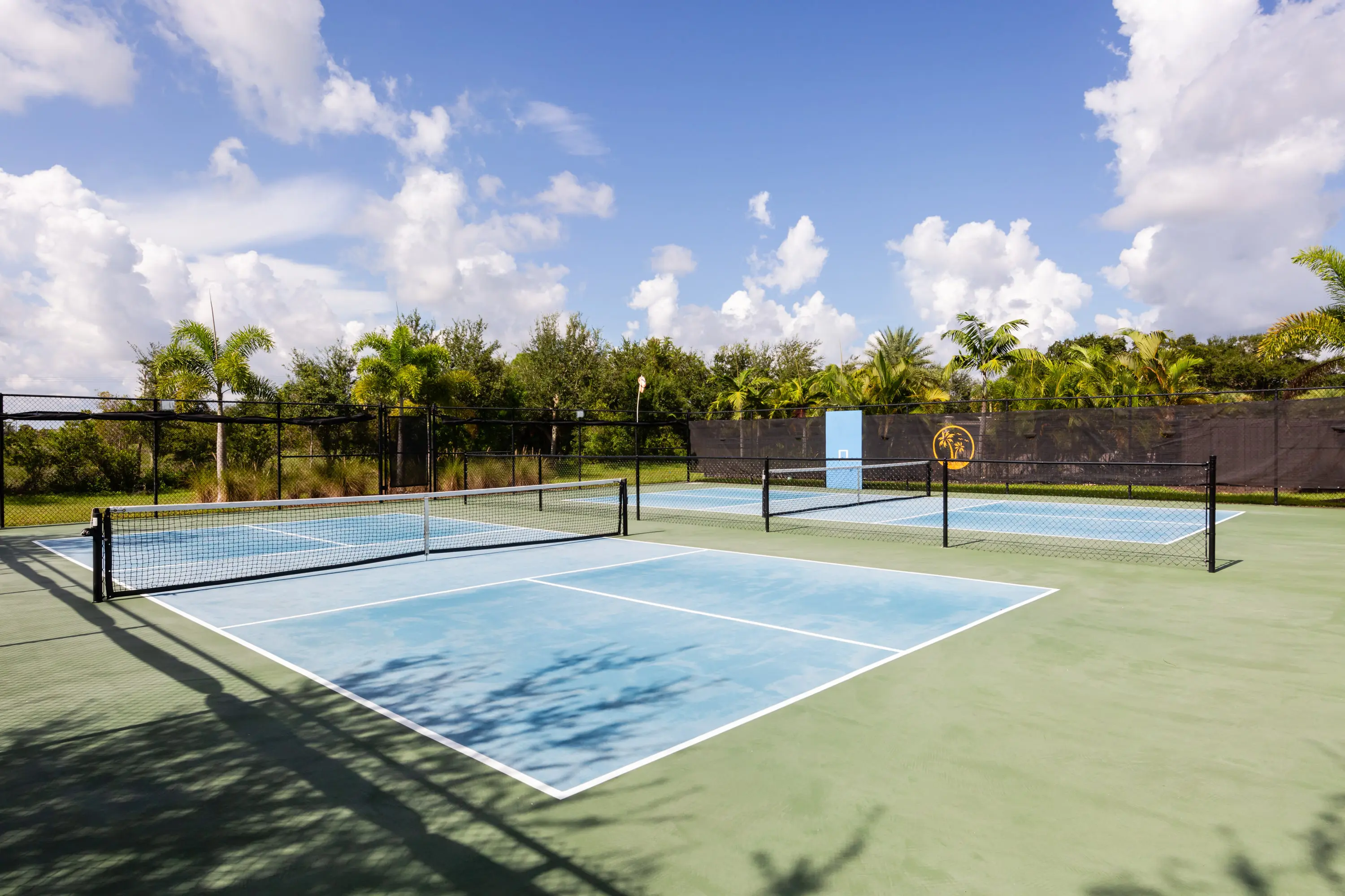 A tennis court with two blue and one green.